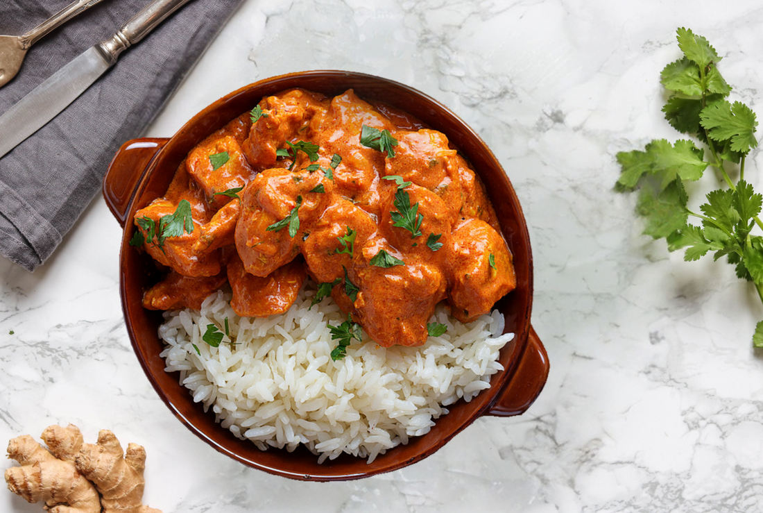 image showing creamy butter chicken and basmati rice in a ceramic bowl